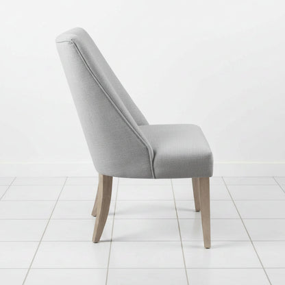 Light grey dining chair with solid wood legs