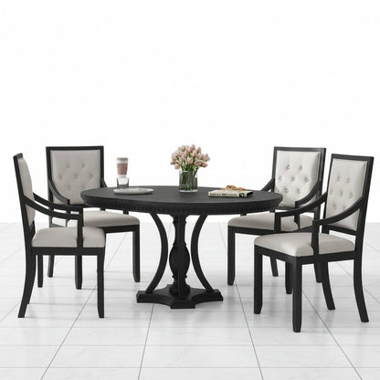 Round dining table with four chairs in black and oak